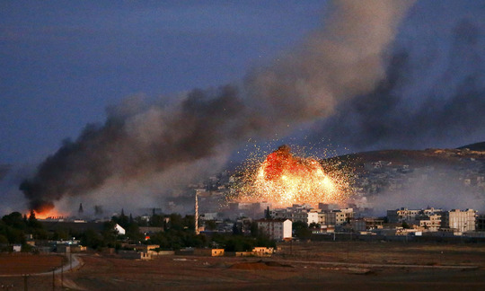 Smoke-and-flames-rise-over-Syrian-town-of-Kobani-after-an-airstrike 1413828595250360 9d75f